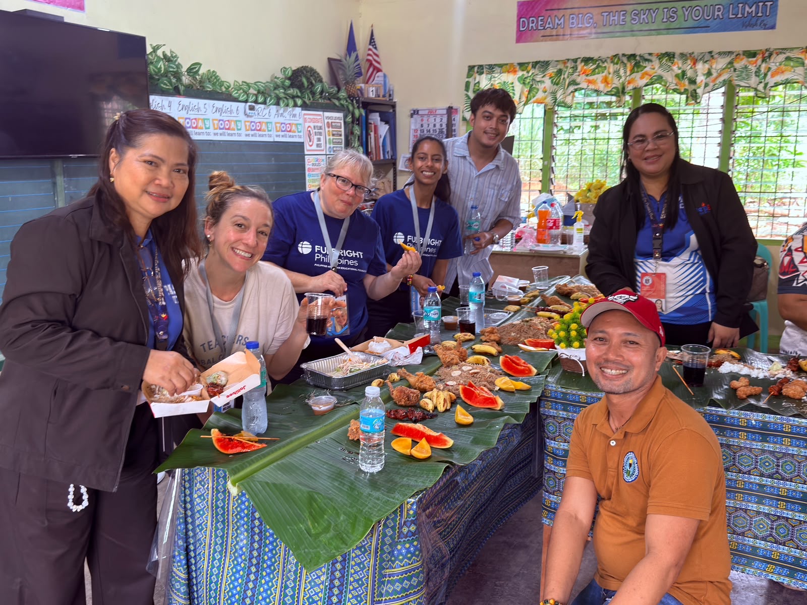 Fulbright teachers and Filipino educators around a shared feast on banana leaves.