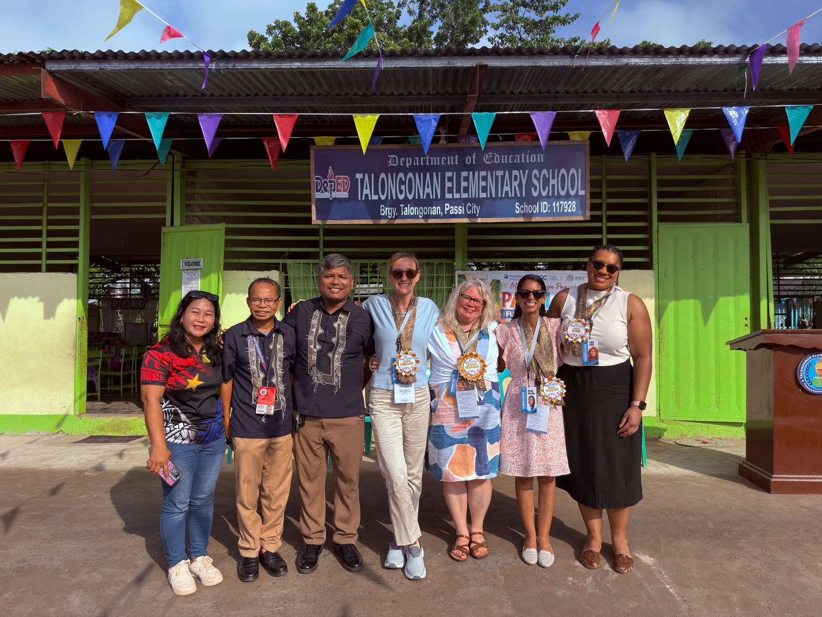 The Fulbright team with local educators in front of the Talongonan Elementary School sign.