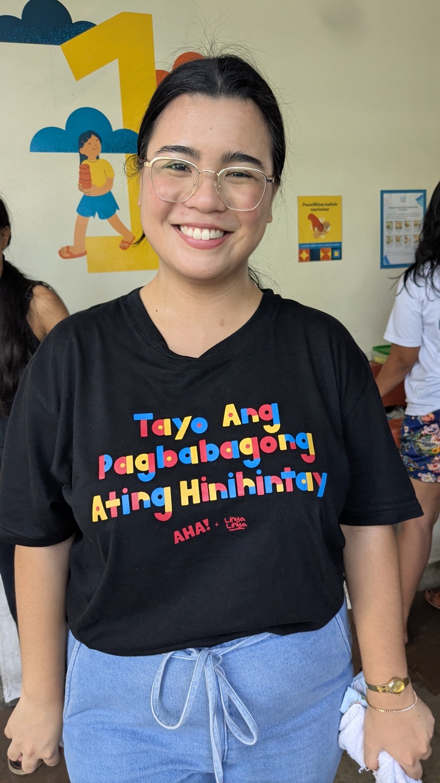 A smiling Filipino educator wearing a shirt that reads Tayo Ang Pagbabagong Ating Hinihintay.