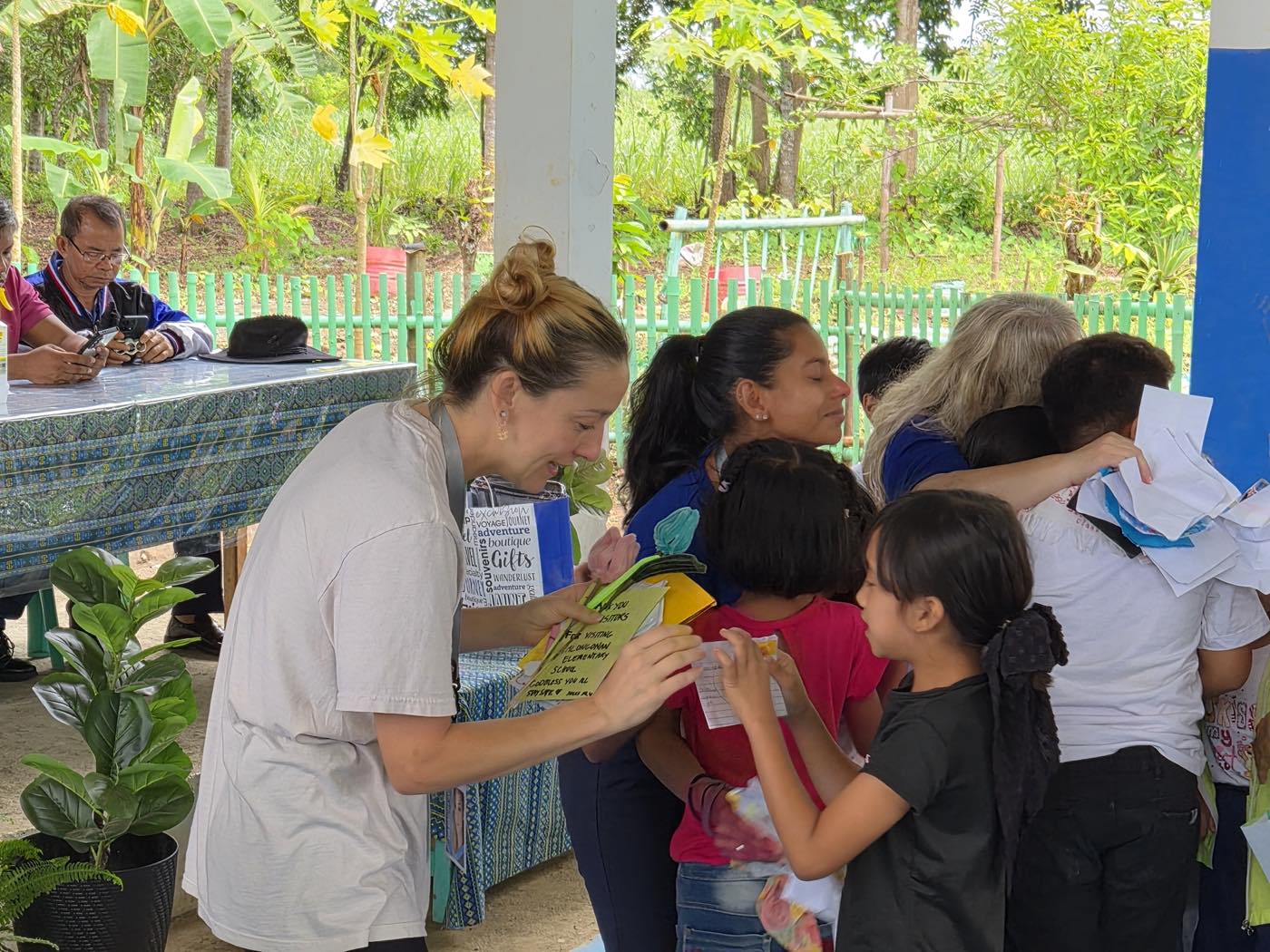 Johna Meldau reading thank-you notes handed to her by students at Talongonan Elementary School.