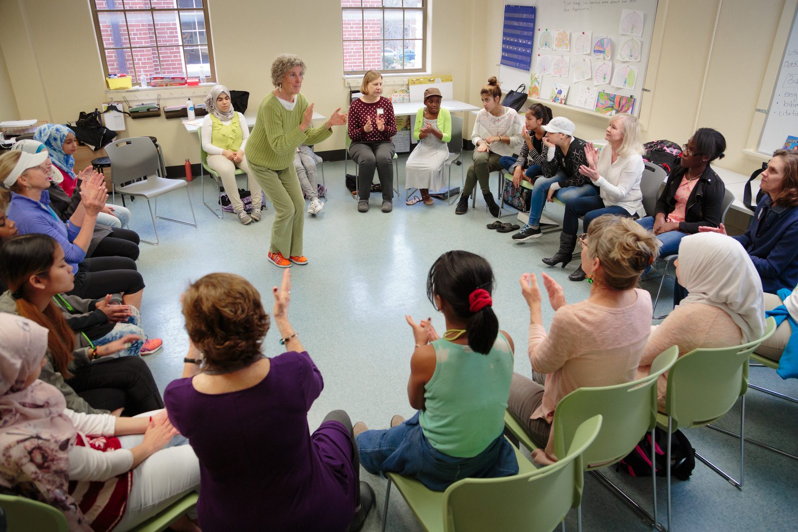 A group seated in a circle in a classroom for a restorative practice session